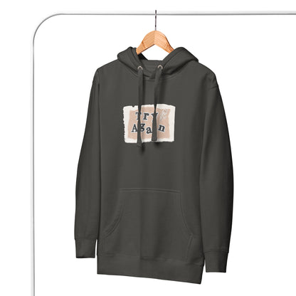 Retry Hoodie - Left Placement image 23: Charcoal Heather version, size 2XL with front view of the Try Again range.