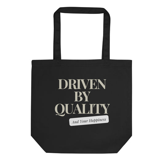 Image 1 of Black Quality Driven Tote Bag - Left Placement, with Driven by Quality artwork visible in front view.
